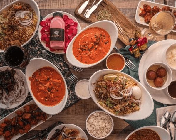 A spread of Kinnera dishes: biryani, curries, appetizers and desserts
